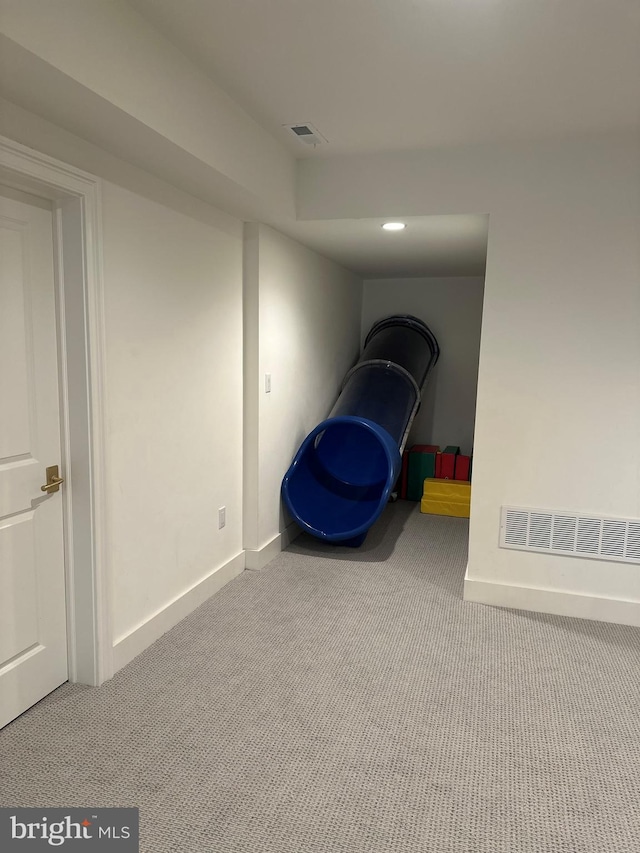 interior space featuring carpet and baseboards
