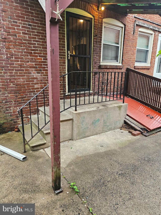 doorway to property with brick siding