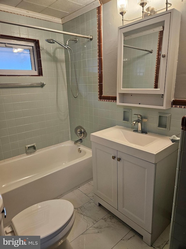 bathroom with marble finish floors, toilet, shower / washtub combination, vanity, and ornamental molding