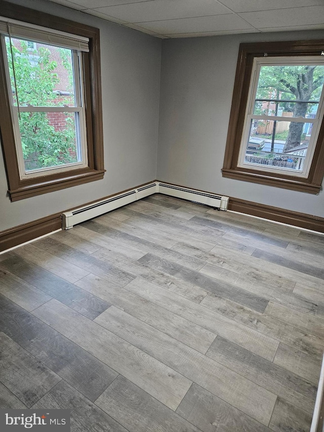 empty room featuring healthy amount of natural light and wood finished floors