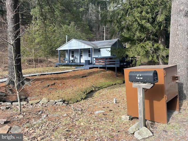 view of front of property with a forest view
