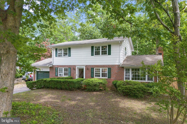 443 Deerwood Dr, Fredericksburg, VA 22401 - view of front facade featuring a garage, brick siding, fence, and a chimney