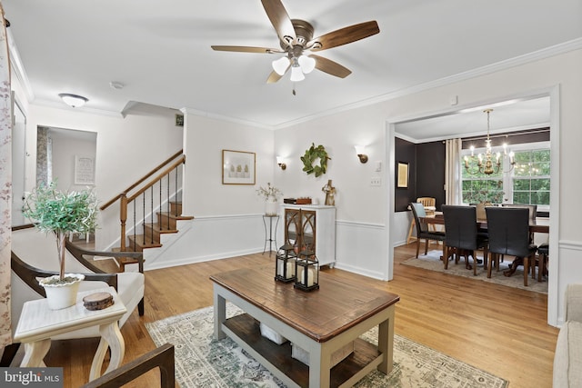 443 Deerwood Dr, Fredericksburg, VA 22401 - living area with light wood-type flooring, a ceiling fan, a chandelier, ornamental molding, and stairs