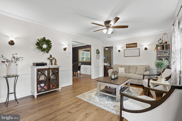 443 Deerwood Dr, Fredericksburg, VA 22401 - living area with light wood-style flooring, a ceiling fan, ornamental molding, and a wainscoted wall