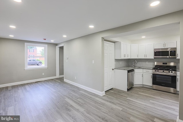 7004 Alden Rd, Pikesville, MD 21208 - kitchen featuring appliances with stainless steel finishes, light wood finished floors, baseboards, backsplash, and recessed lighting