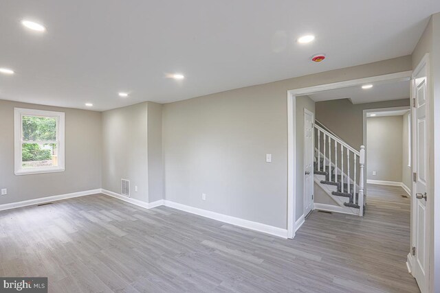 7004 Alden Rd, Pikesville, MD 21208 - empty room featuring wood finished floors, baseboards, stairs, recessed lighting, and a smoke detector