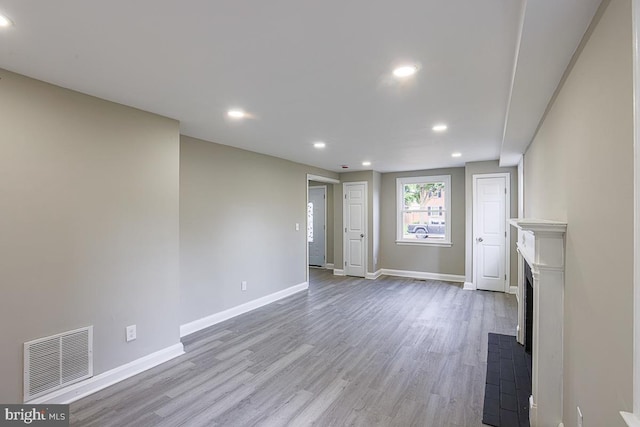 7004 Alden Rd, Pikesville, MD 21208 - unfurnished living room with wood finished floors, recessed lighting, baseboards, and a fireplace