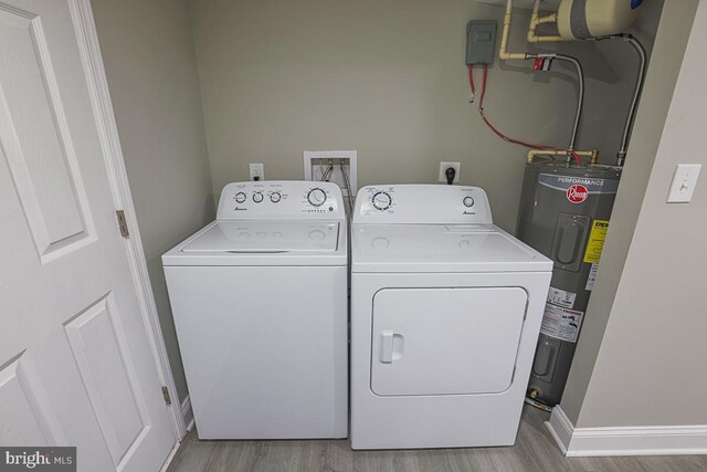 7004 Alden Rd, Pikesville, MD 21208 - washroom featuring electric water heater, independent washer and dryer, and light wood-style flooring