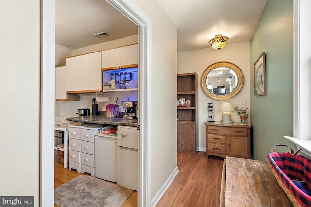 38967 Willow Ln, Fenwick Island, DE 19944 - kitchen with light wood finished floors, white cabinetry, and fridge