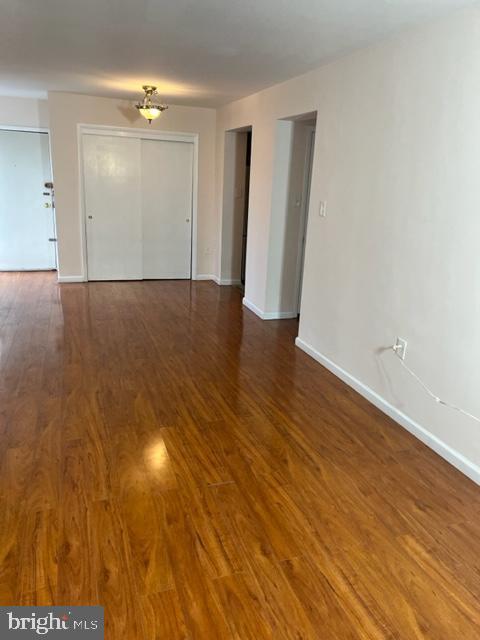 9250 Edwards Way Unit 101-A, Hyattsville, MD 20783 - spare room with wood finished floors and baseboards