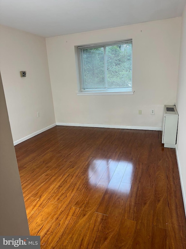 9250 Edwards Way Unit 101-A, Hyattsville, MD 20783 - unfurnished room with baseboards and wood finished floors