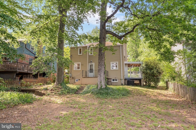 rear view of property with fence and central AC