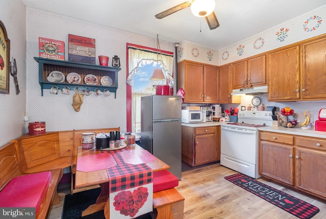 309 N N Morris St, Shippensburg, PA 17257 - kitchen featuring white appliances, under cabinet range hood, wallpapered walls, light wood-type flooring, and ceiling fan