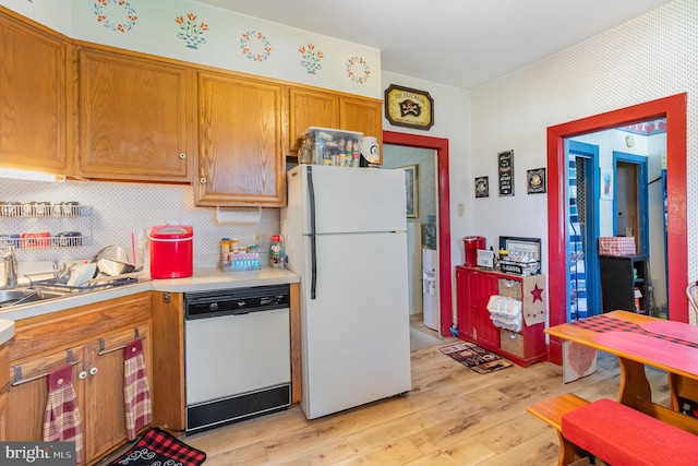 309 N N Morris St, Shippensburg, PA 17257 - kitchen with white appliances, light countertops, light wood finished floors, and brown cabinets