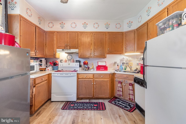 309 N N Morris St, Shippensburg, PA 17257 - kitchen featuring white appliances, under cabinet range hood, light countertops, light wood-style floors, and brown cabinetry