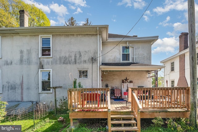 309 N N Morris St, Shippensburg, PA 17257 - back of house featuring fence, a deck, stucco siding, and a chimney