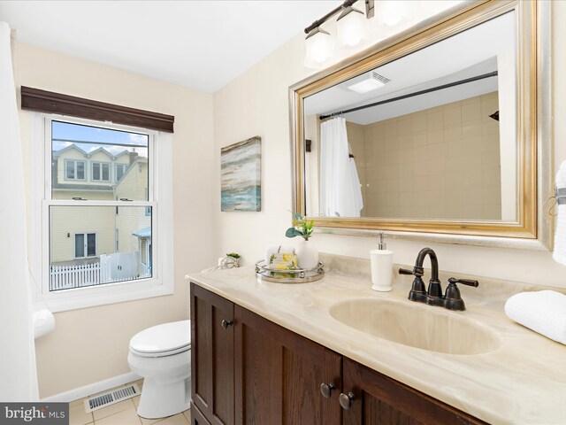 623 Second St, Annapolis, MD 21403 - bathroom featuring tile patterned flooring, baseboards, vanity, and toilet