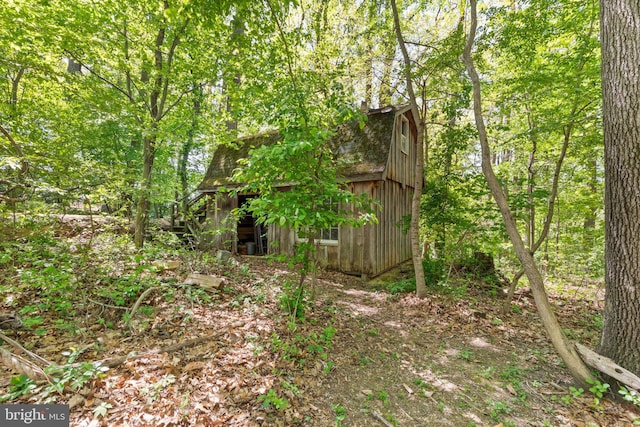 view of barn featuring a view of trees