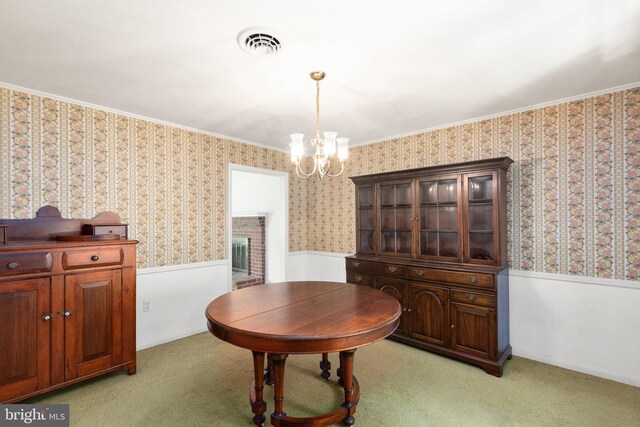 dining room with wallpapered walls, a chandelier, visible vents, and a wainscoted wall