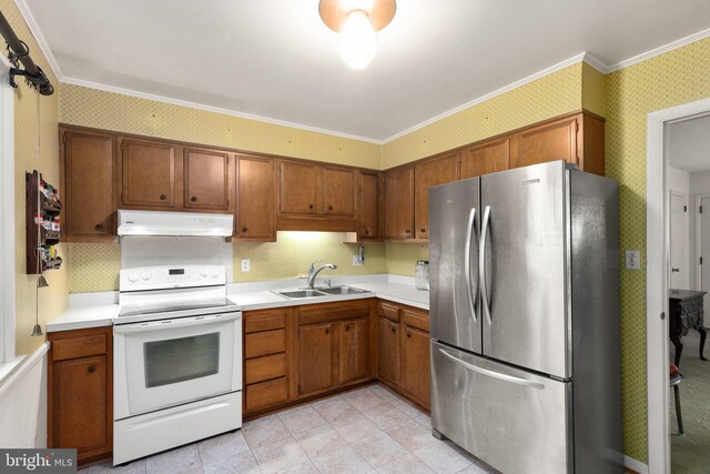 kitchen with freestanding refrigerator, wallpapered walls, under cabinet range hood, white electric stove, and a sink