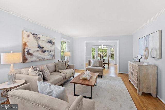 living room featuring light wood-type flooring, ornamental molding, and baseboards