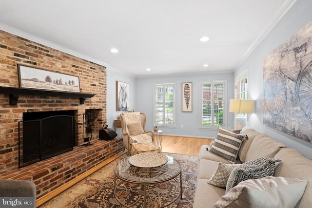living area featuring wood finished floors, recessed lighting, crown molding, a brick fireplace, and baseboards