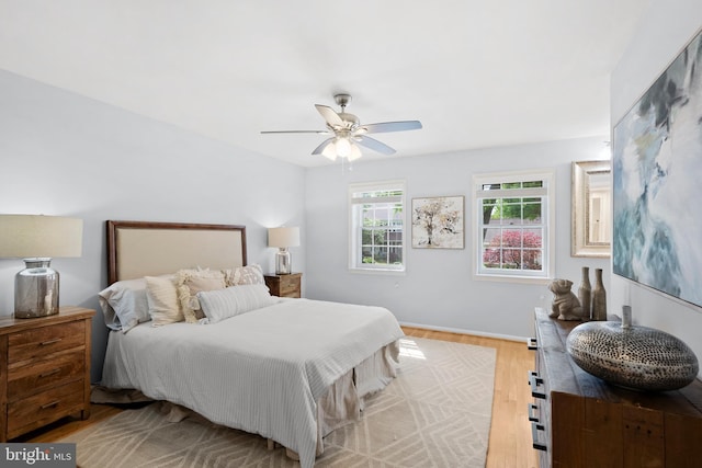 bedroom with wood finished floors, ceiling fan, and baseboards