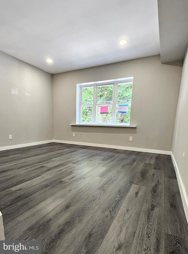 unfurnished room with recessed lighting, baseboards, and wood finished floors