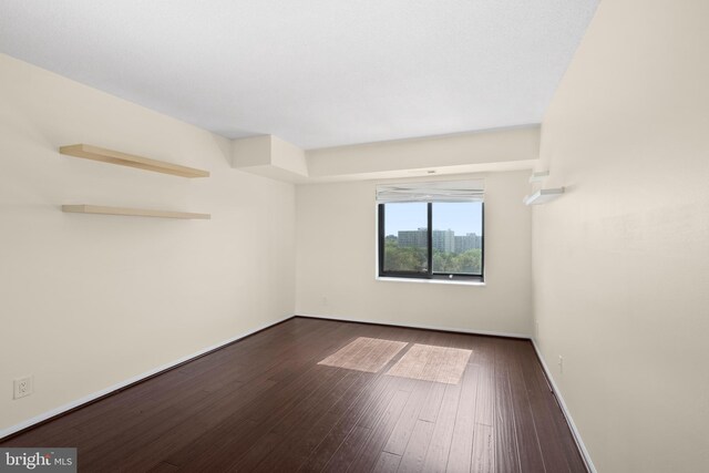 307 Yoakum Pkwy Unit 821, Alexandria, VA 22304 - empty room with dark wood-style floors and baseboards