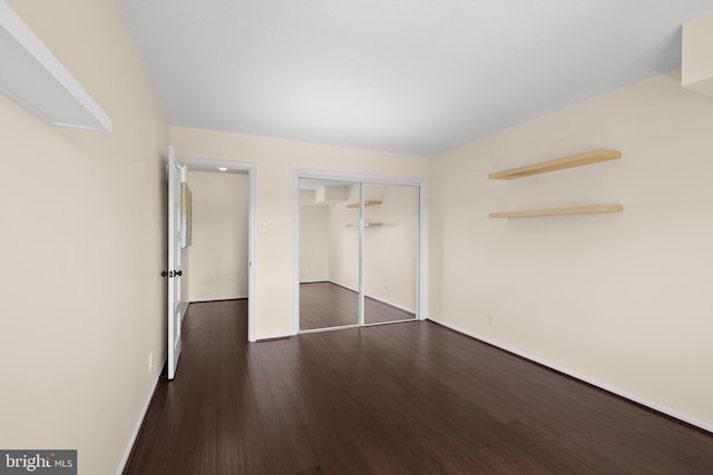 307 Yoakum Pkwy Unit 821, Alexandria, VA 22304 - unfurnished bedroom with dark wood-style floors, a closet, and baseboards