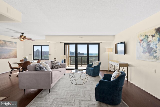 307 Yoakum Pkwy Unit 821, Alexandria, VA 22304 - living room featuring healthy amount of natural light, wood finished floors, ceiling fan, baseboards, and a textured ceiling