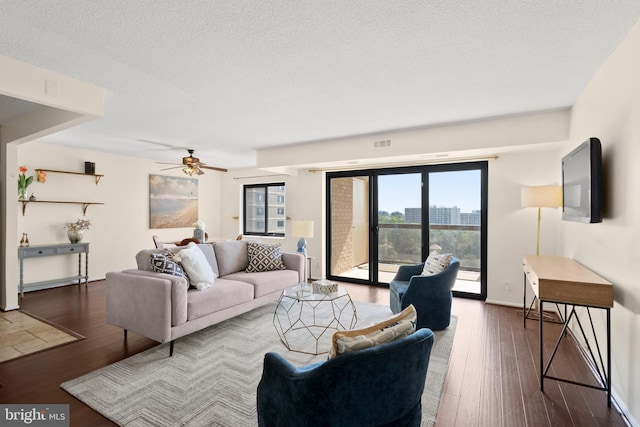 307 Yoakum Pkwy Unit 821, Alexandria, VA 22304 - living room with hardwood / wood-style floors, a ceiling fan, baseboards, and a textured ceiling