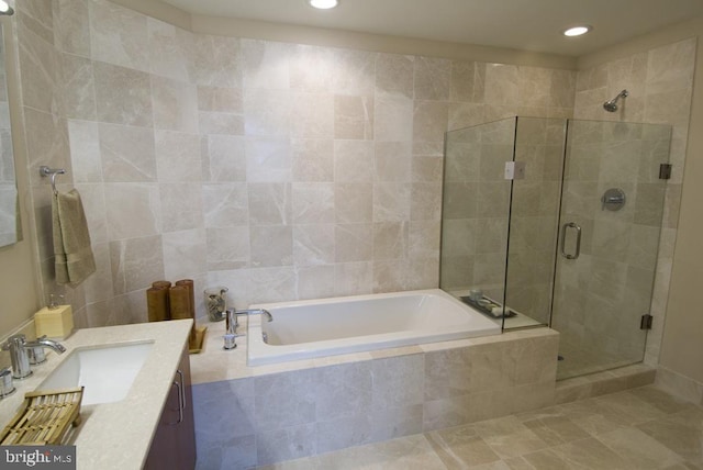 full bath with a stall shower, vanity, a garden tub, and recessed lighting