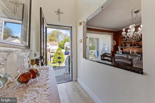15 Sutton Pl, Helmetta, NJ 08828 - doorway featuring crown molding, baseboards, an inviting chandelier, and wood finished floors