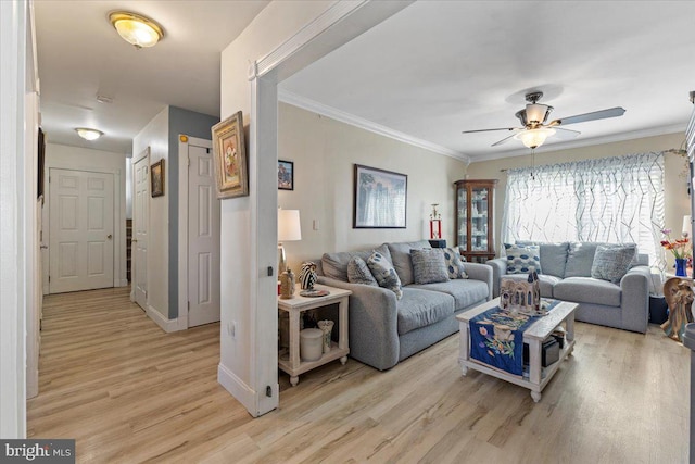 15 Sutton Pl, Helmetta, NJ 08828 - living room featuring a ceiling fan, baseboards, light wood finished floors, and crown molding