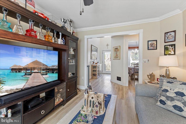15 Sutton Pl, Helmetta, NJ 08828 - living room with ornamental molding, light wood-type flooring, baseboards, and a chandelier