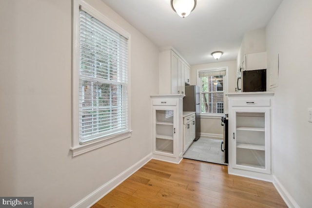 entryway with light wood-type flooring and baseboards