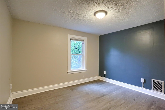 235 Wyoming Ave, Enola, PA 17025 - spare room featuring wood finished floors, a textured ceiling, and baseboards