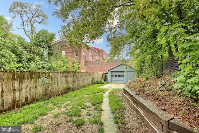 235 Wyoming Ave, Enola, PA 17025 - fenced backyard featuring an outdoor structure, a detached garage, and driveway
