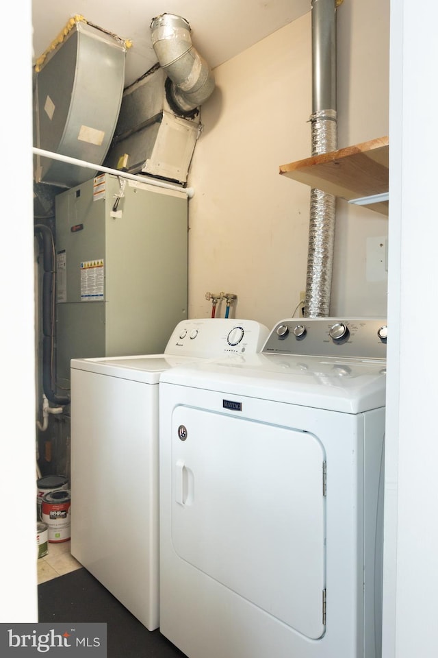 laundry room with washing machine and clothes dryer and laundry area