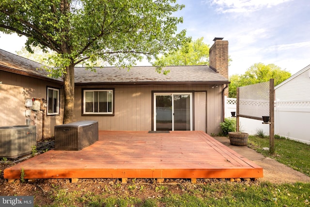 wooden terrace featuring central air condition unit and fence