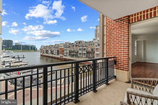 balcony featuring a water view and a view of city