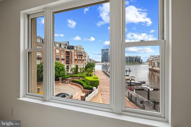 doorway to outside featuring a water view, plenty of natural light, and a city view