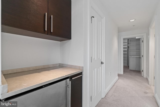 hallway featuring light colored carpet, baseboards, and recessed lighting