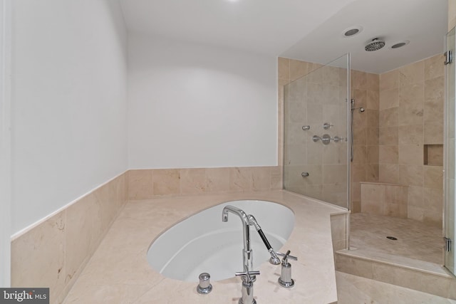 full bathroom with a garden tub and a stall shower