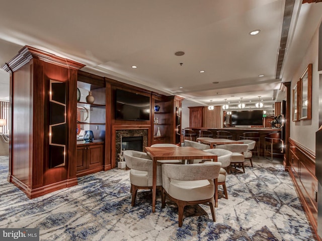 dining area featuring a premium fireplace and recessed lighting