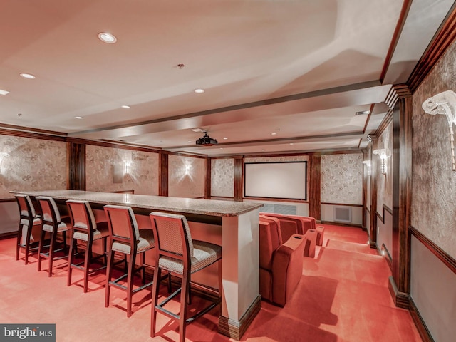 cinema with wallpapered walls, a community bar, light colored carpet, recessed lighting, and a decorative wall