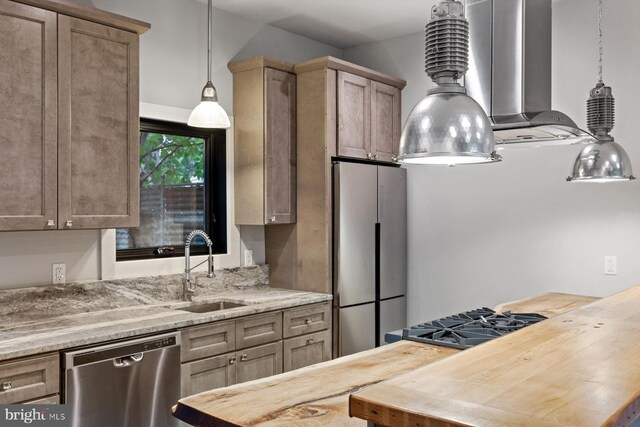 10 Mccready Aly, Lambertville, NJ 08530 - kitchen with stainless steel appliances, a sink, wall chimney exhaust hood, decorative light fixtures, and wooden counters