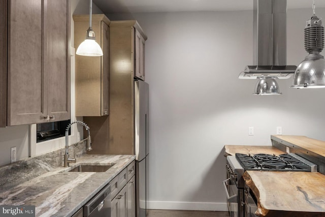 10 Mccready Aly, Lambertville, NJ 08530 - kitchen with a sink, appliances with stainless steel finishes, baseboards, decorative light fixtures, and light stone counters