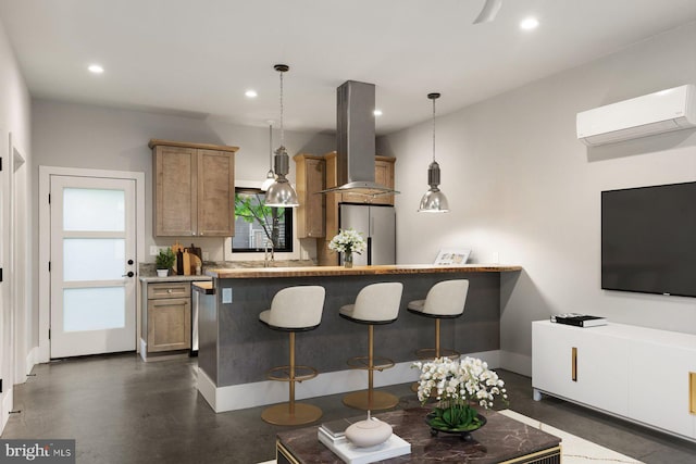 10 Mccready Aly, Lambertville, NJ 08530 - kitchen with island exhaust hood, an AC wall unit, freestanding refrigerator, a kitchen breakfast bar, and recessed lighting